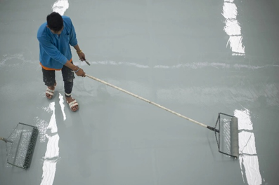 Worker applying polyurea coating